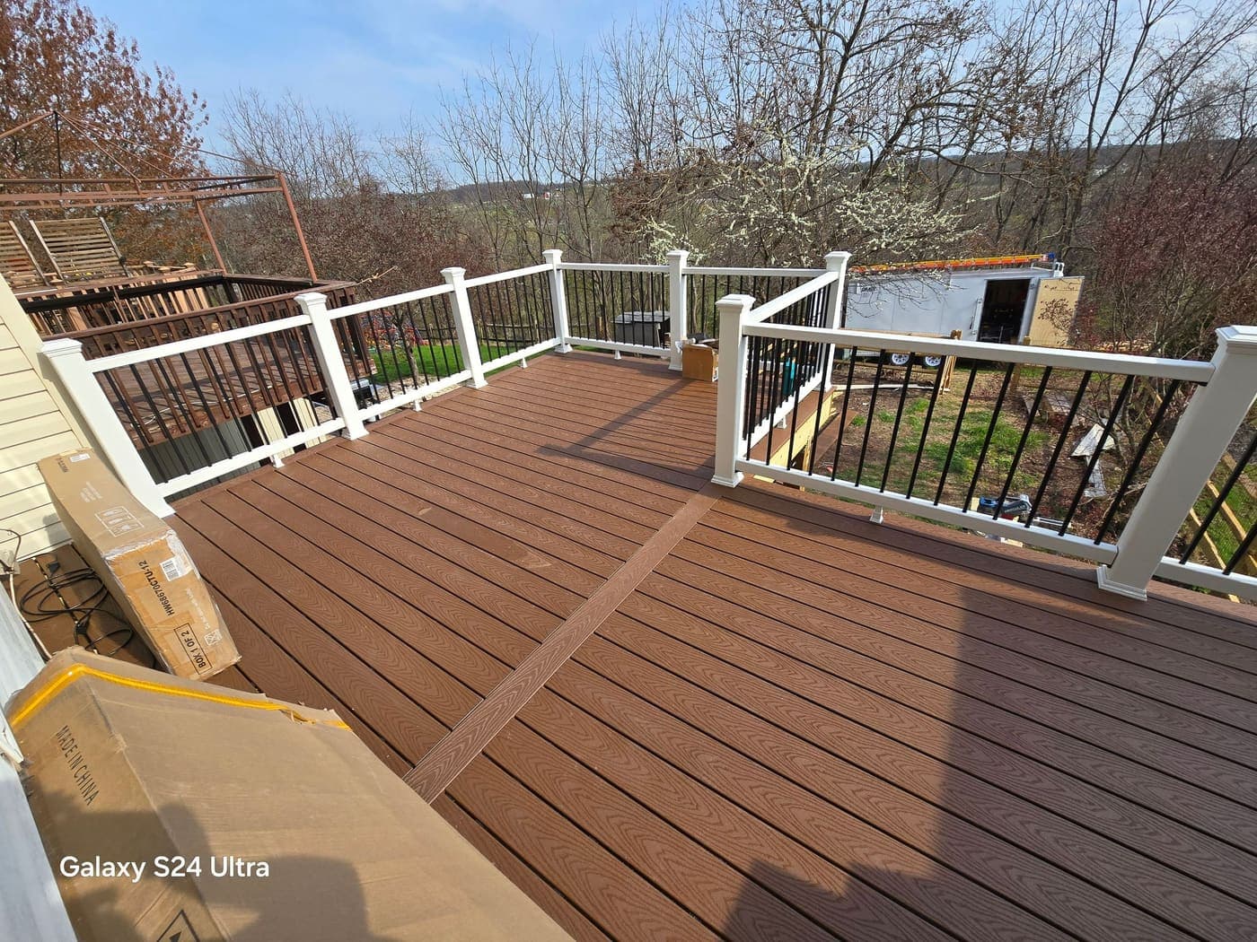 Custom backyard deck with railings and stairs